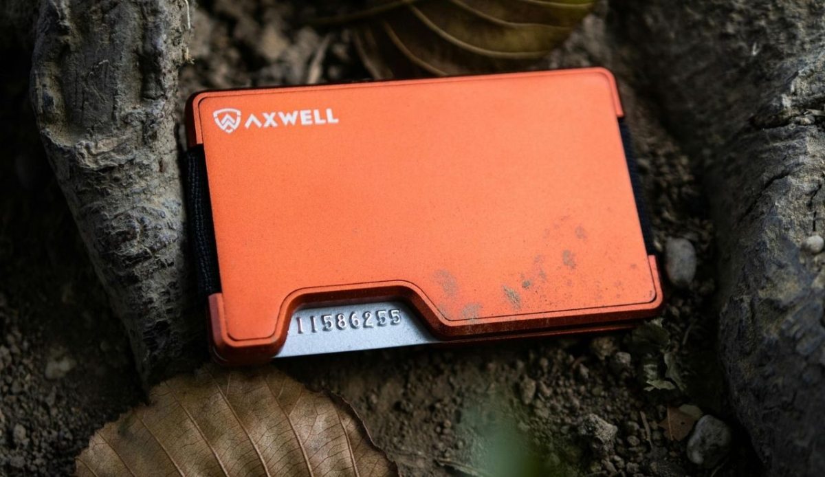 10 Must-Have Essentials for Your Next Cruise 5 orange Axwell RFID wallet placed on forest ground