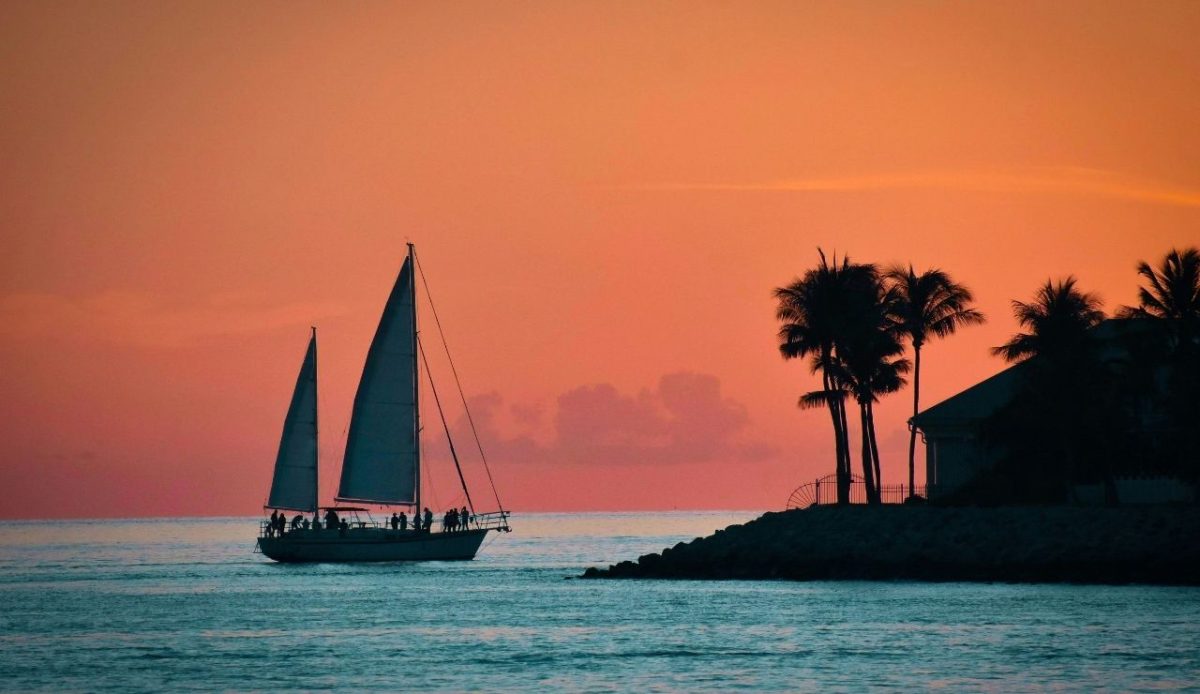 10 East Coast States With Sunsets You’ll Never Forget 10 sunset sailboat near palm-lined shore, Key West Florida