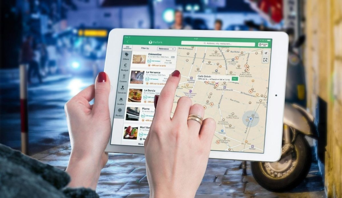 What To Know About Airbnb Experiences Before You Book 3 Person using tablet for map