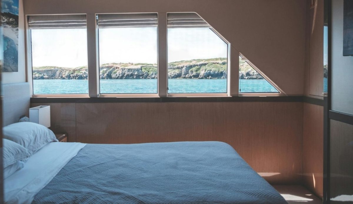 Comfortable bed in boat cabin during cruise           