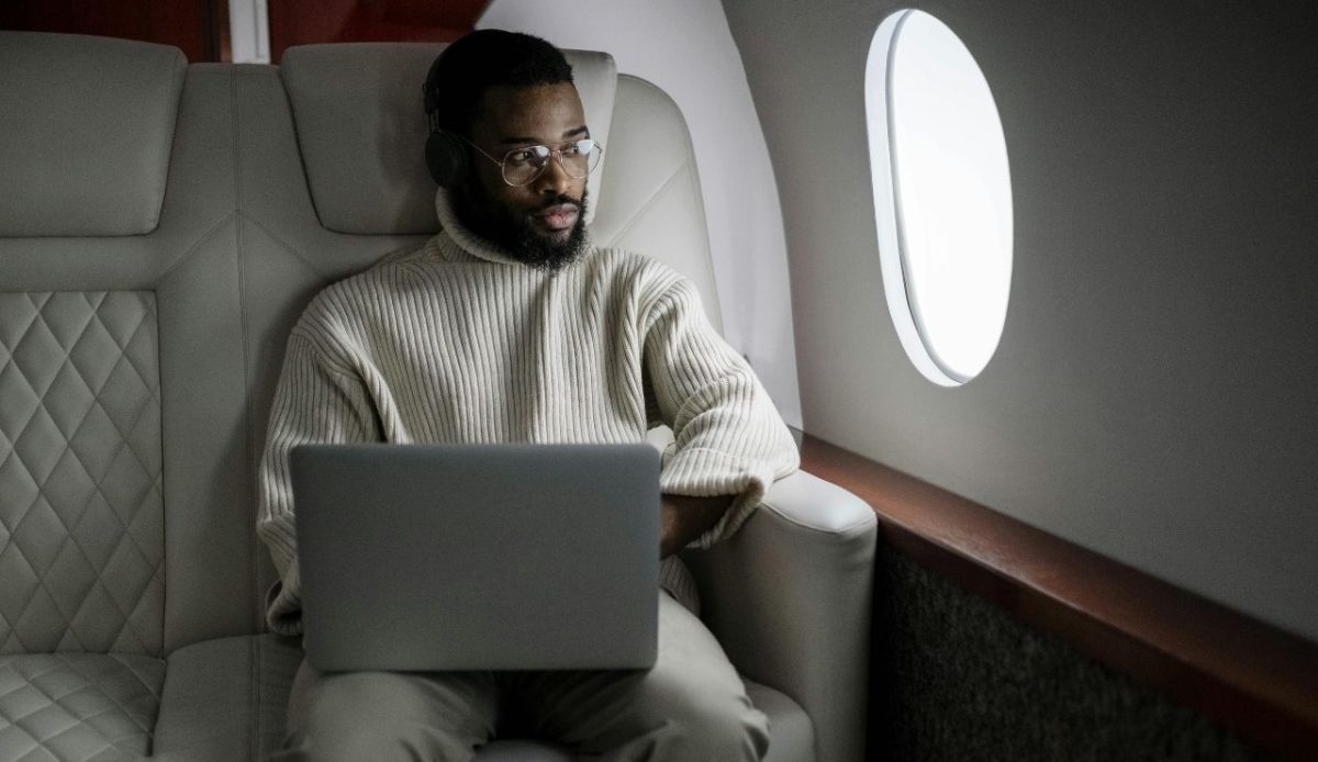 man sitting in luxury plane seat       