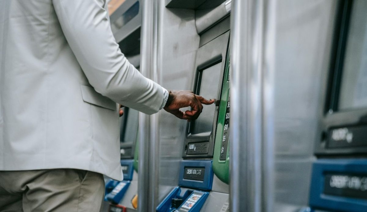 A Person using a Ticket Machine       