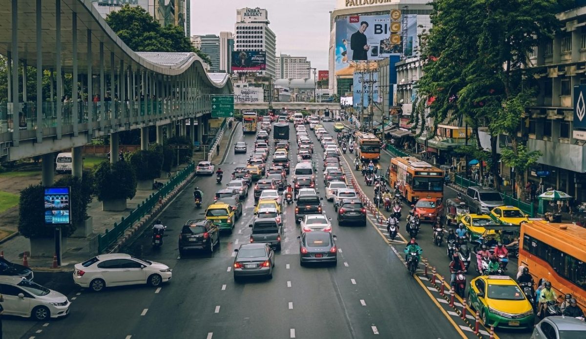 A busy city street with many cars and buses, Bangkok, Thailand                   
