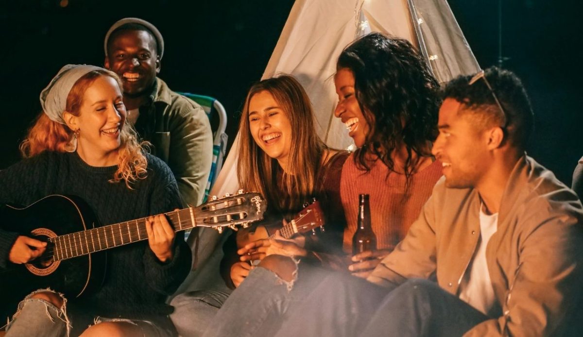 A group of friends singing in night      