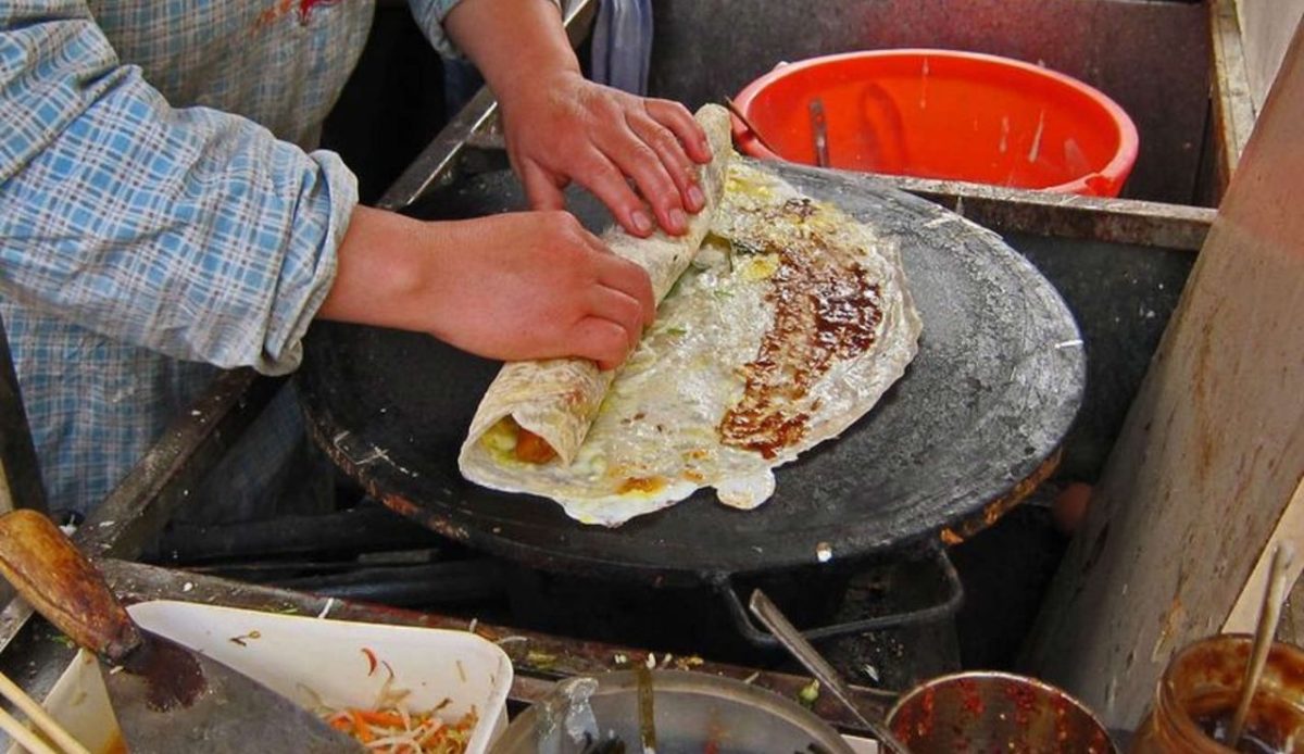 A person is making bread at dirty place                