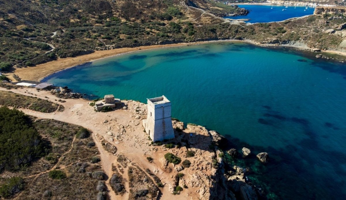 Aerial view of Għajn Tuffieħa Tower overlooking the turquoise bay in Malta             
