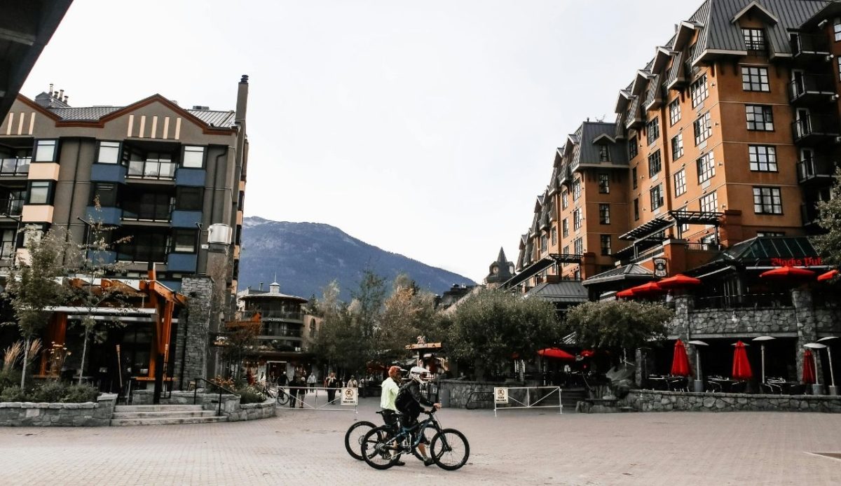 Bikers Walking with their Bikes in Whistler Canada              
