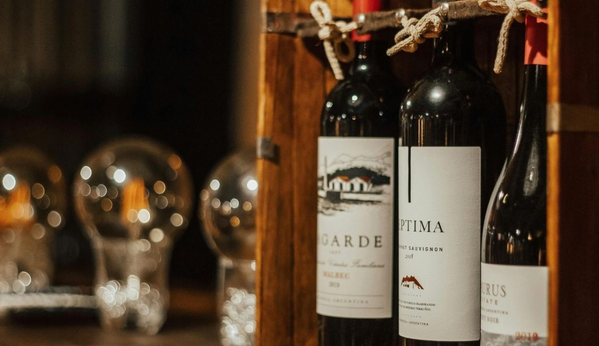 Bottles of wine in wooden box arranged on table             