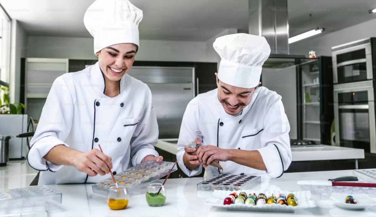 Latin chocolatiers preparing Mexican bonbon candies in a kitchen in Mexico                       