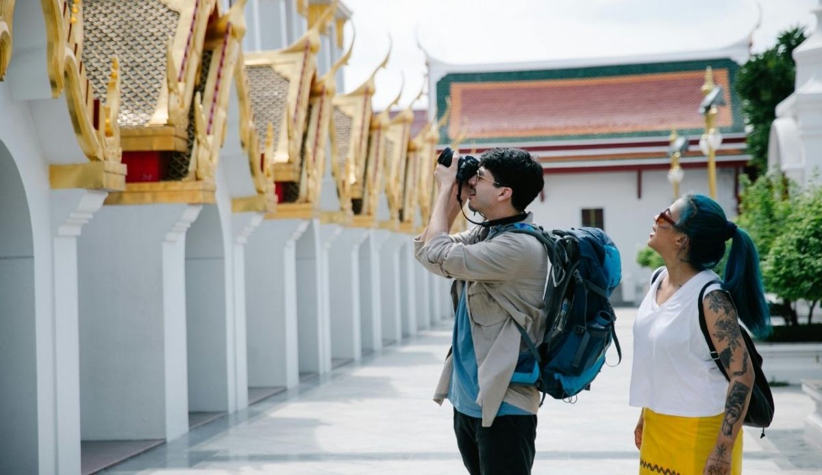 Man Taking Photo of a Temple ignoring local cultural norms            