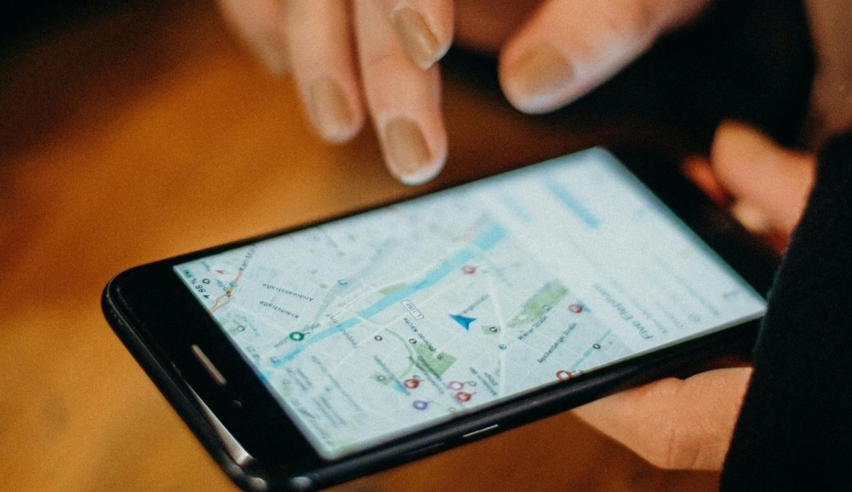 Person Holding Black Android Smartphone checking location           