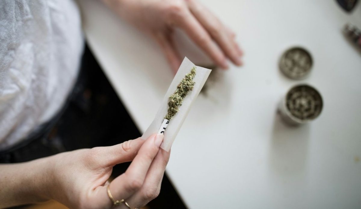 Person preparing cannabis on a table            