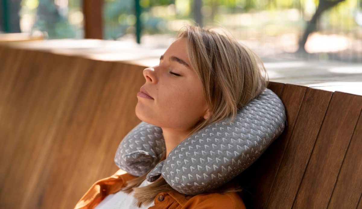 Sleeping person getting a nap using travel pillow (neck pillow)                                  