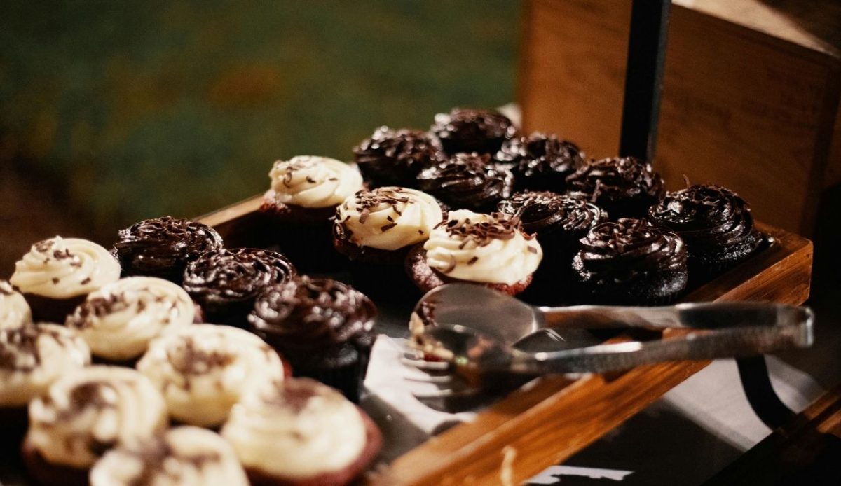Tray of chocolate and vanilla frosted cupcakes on a buffet dessert station                