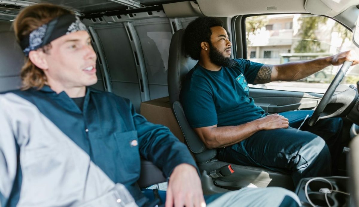 Two passengers  without seatbelts riding in a moving vehicle             