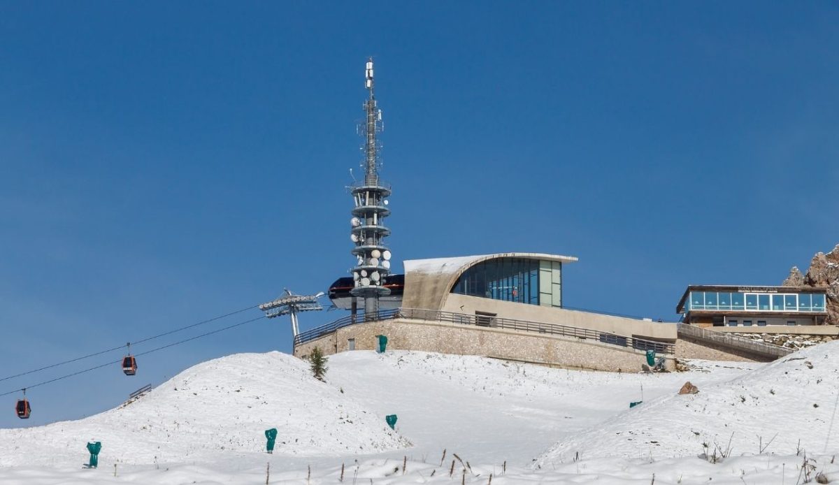 Upper terminus of the Dantercëpies aerial cableway in summer after an early snowfall                 