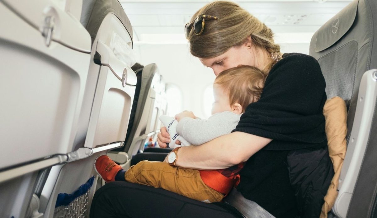 a traveler woman with her lap infant                      