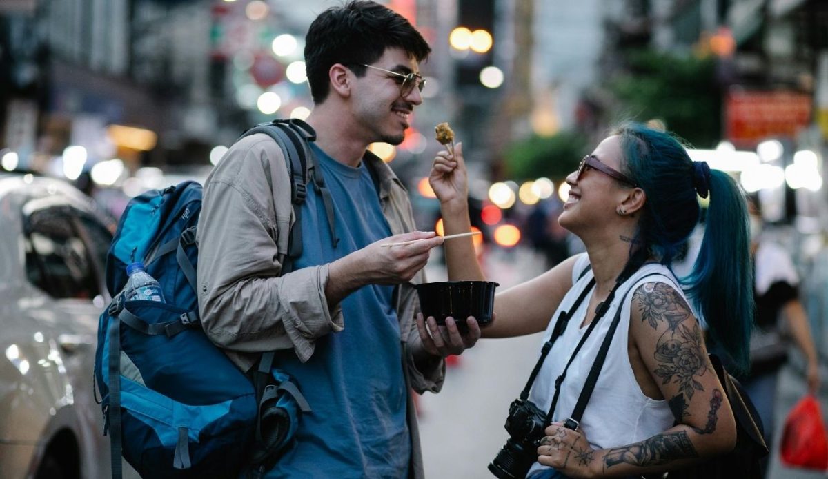 a women is giving a food bite to man                    