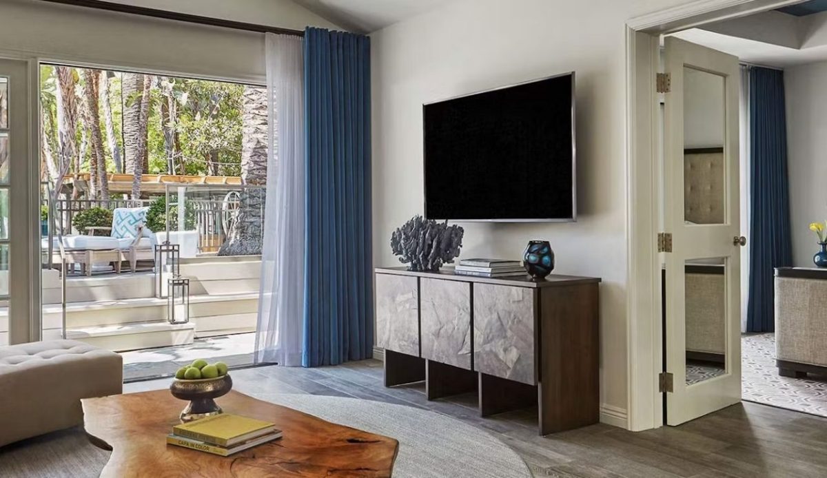 beautiful room with table and LCD hanging at wall       