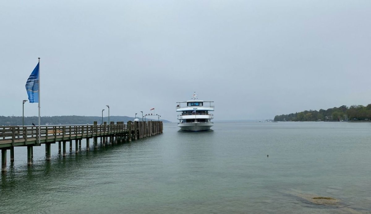 cruise ship docked at small port              