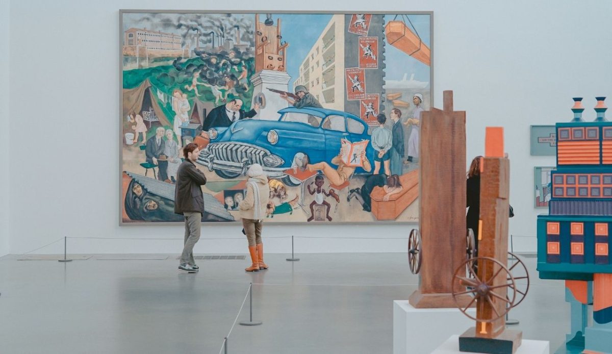 man and woman inside museum watching painting                  