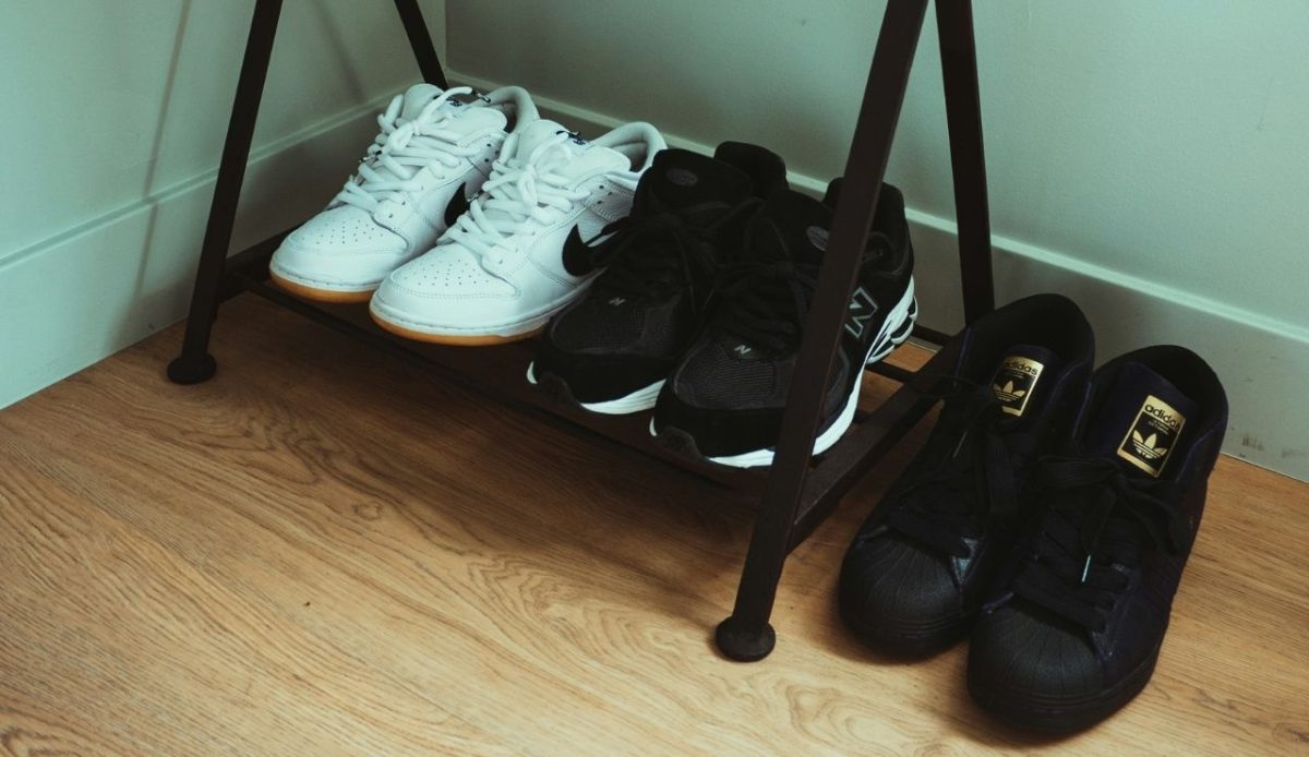 multiple pair of shoes on wooden floor                                  