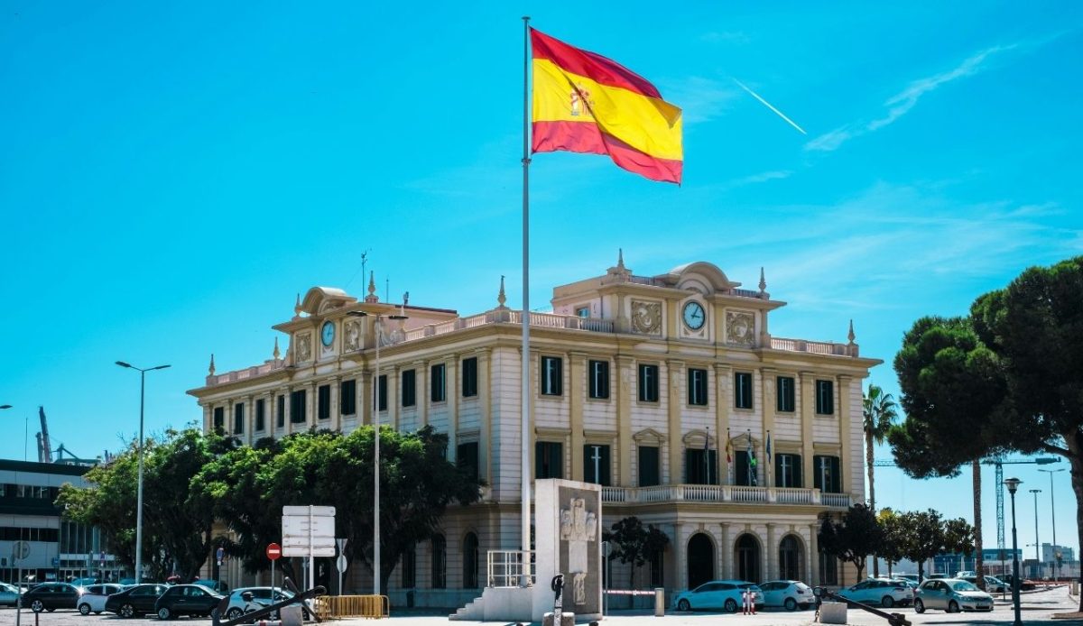 The Spanish flag flying near Malaga Port in Spain               