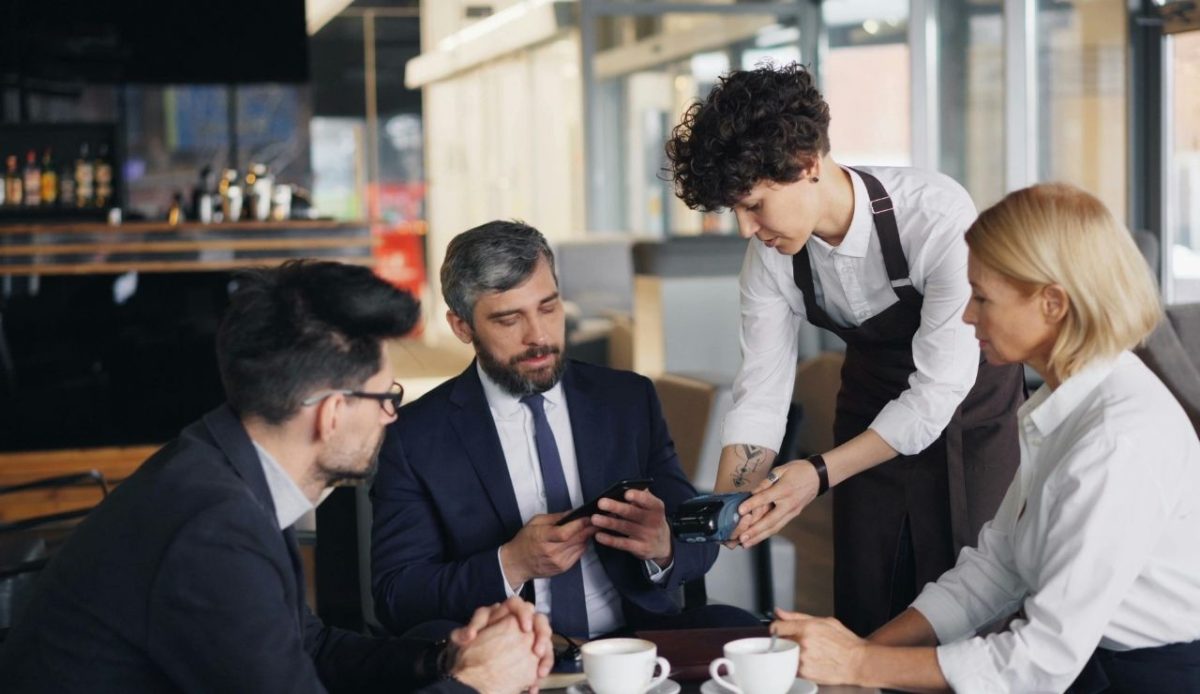 waiter is showing resort fee bill to customer                            