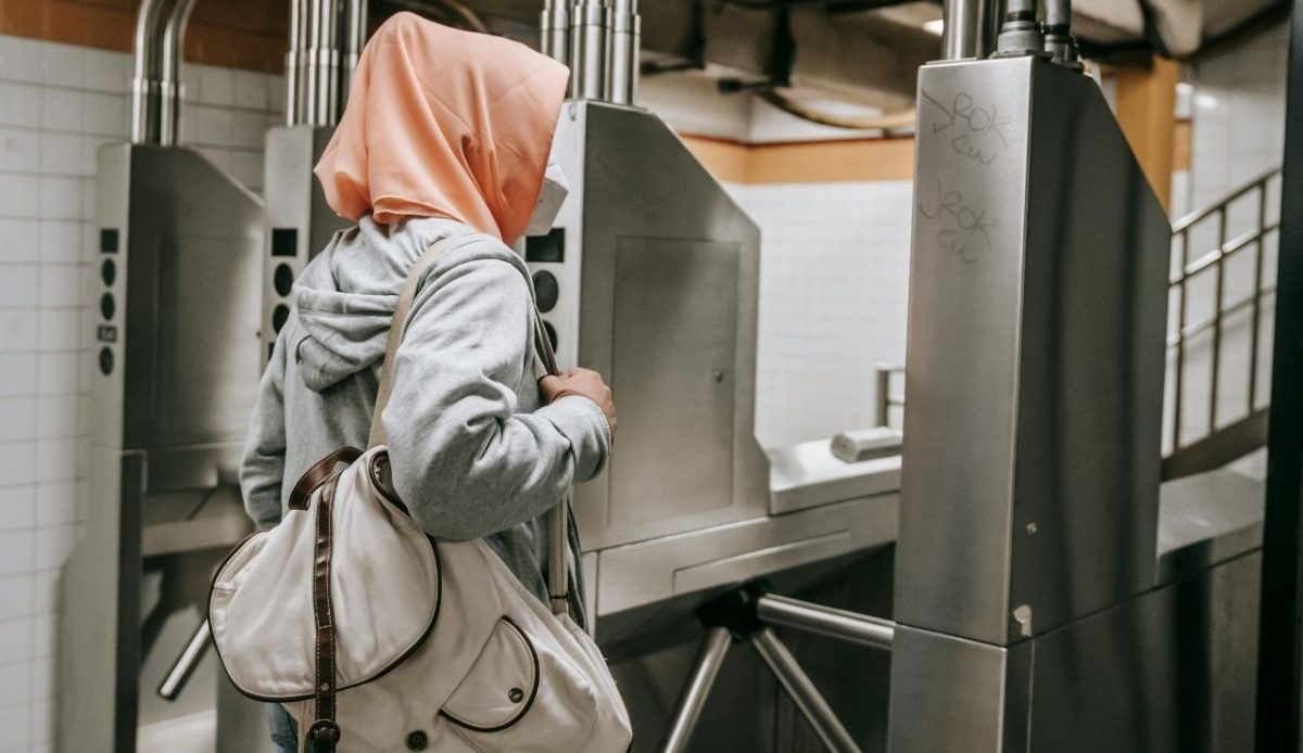 woman crosses through security check in gate                       