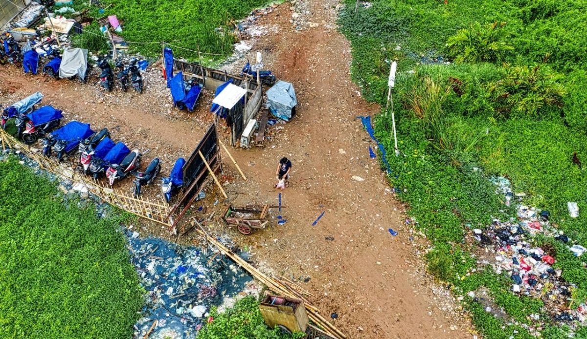 Aerial Photography of Motorcycles Parked Near Green Field with garbage, Jakarta, Indonesia               