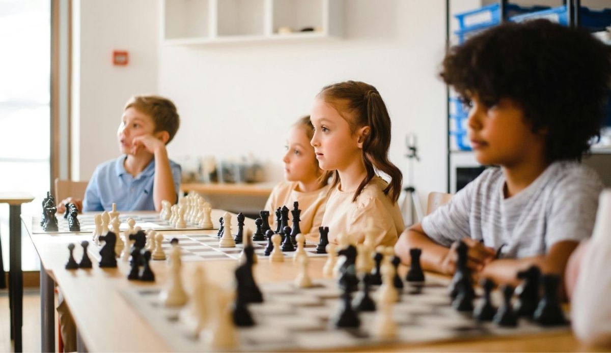 Boys and Girls Playing Chess on Table                       