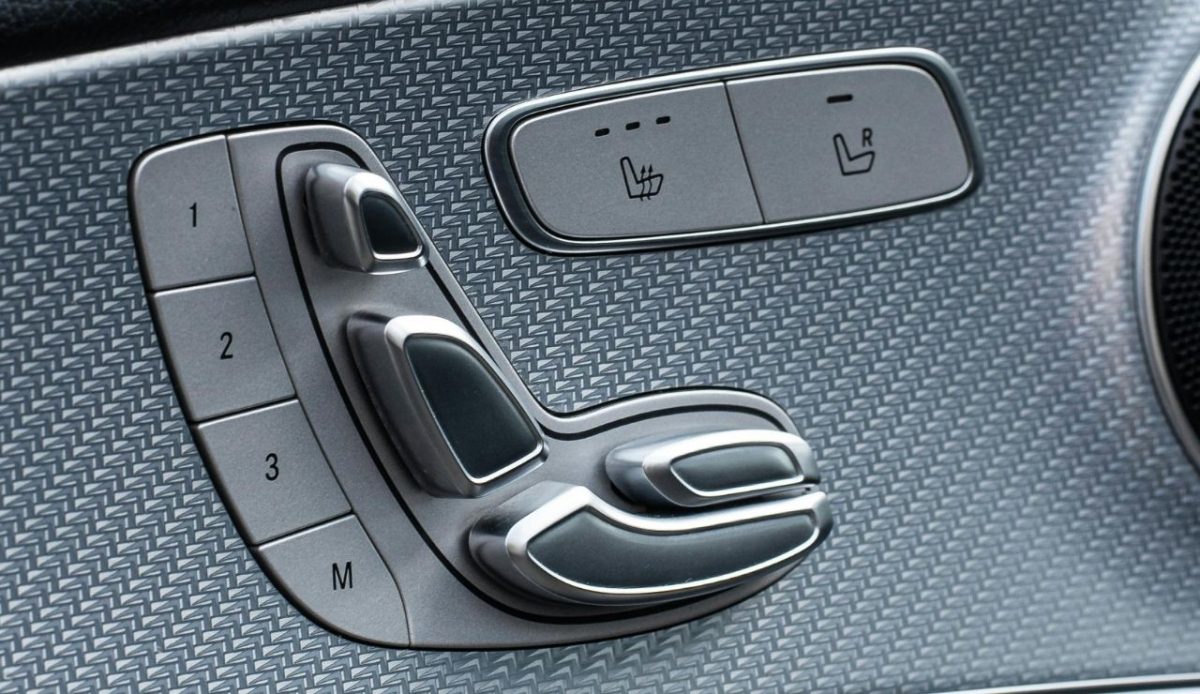 Car door panel with power seat adjustment controls and memory buttons                          