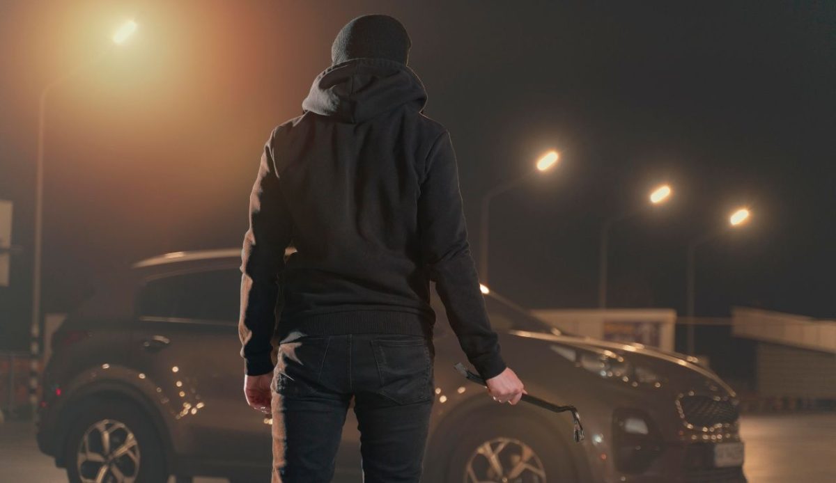 Close up on man trying to break into a car               