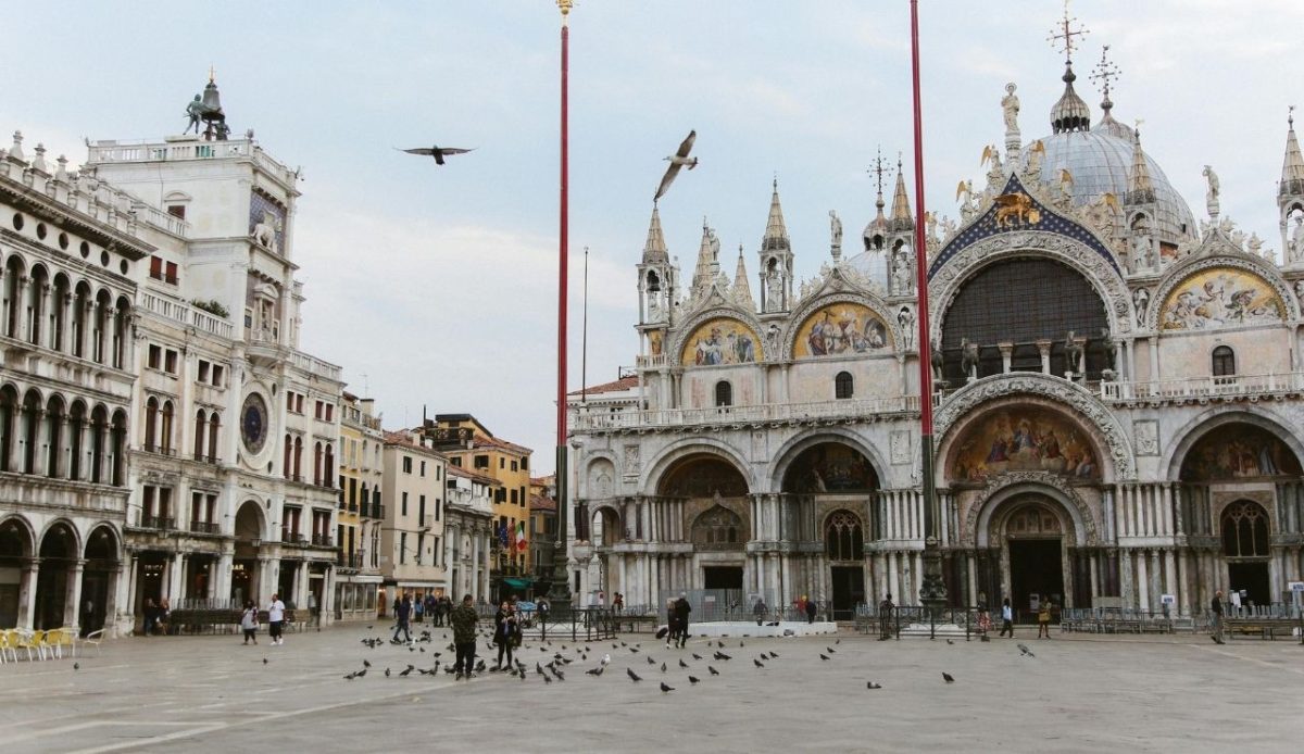 Feeding Pigeons Near St Mark’s Square In Venice                          