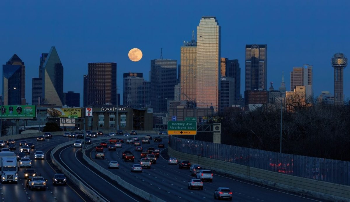 Full moon rising over downtown skyline, Dallas,Texas,USA
