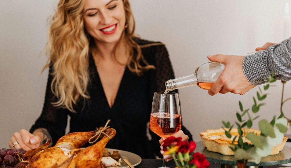 Man Pouring Wine Into Woman's Glass                  