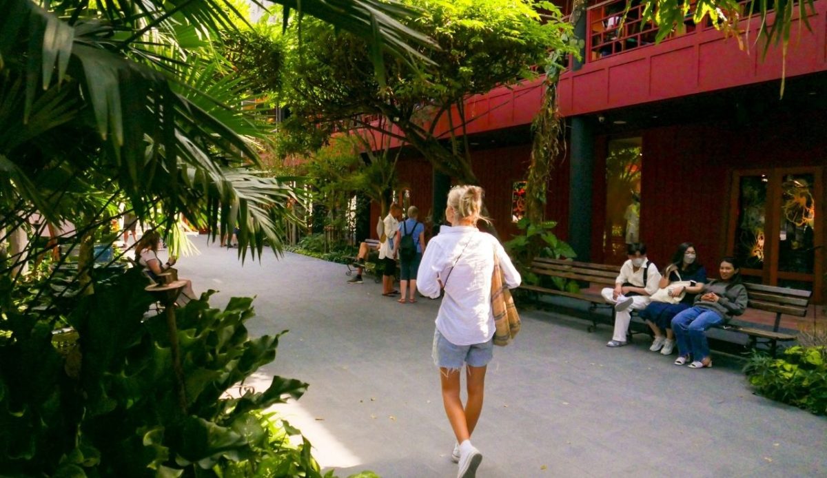 girl walking next to palm streets  Bangkok, Thailand                      
