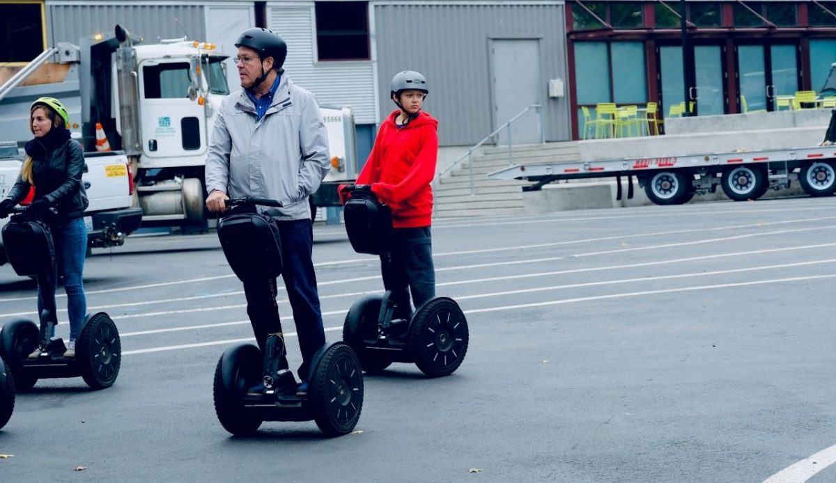 People riding Segway                      