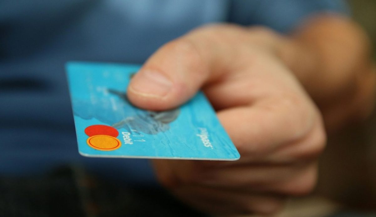 Person Holding Debit Card                      