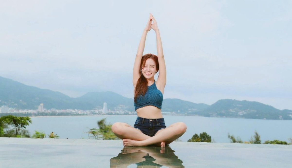 Woman Doing Yoga on Poolside                   