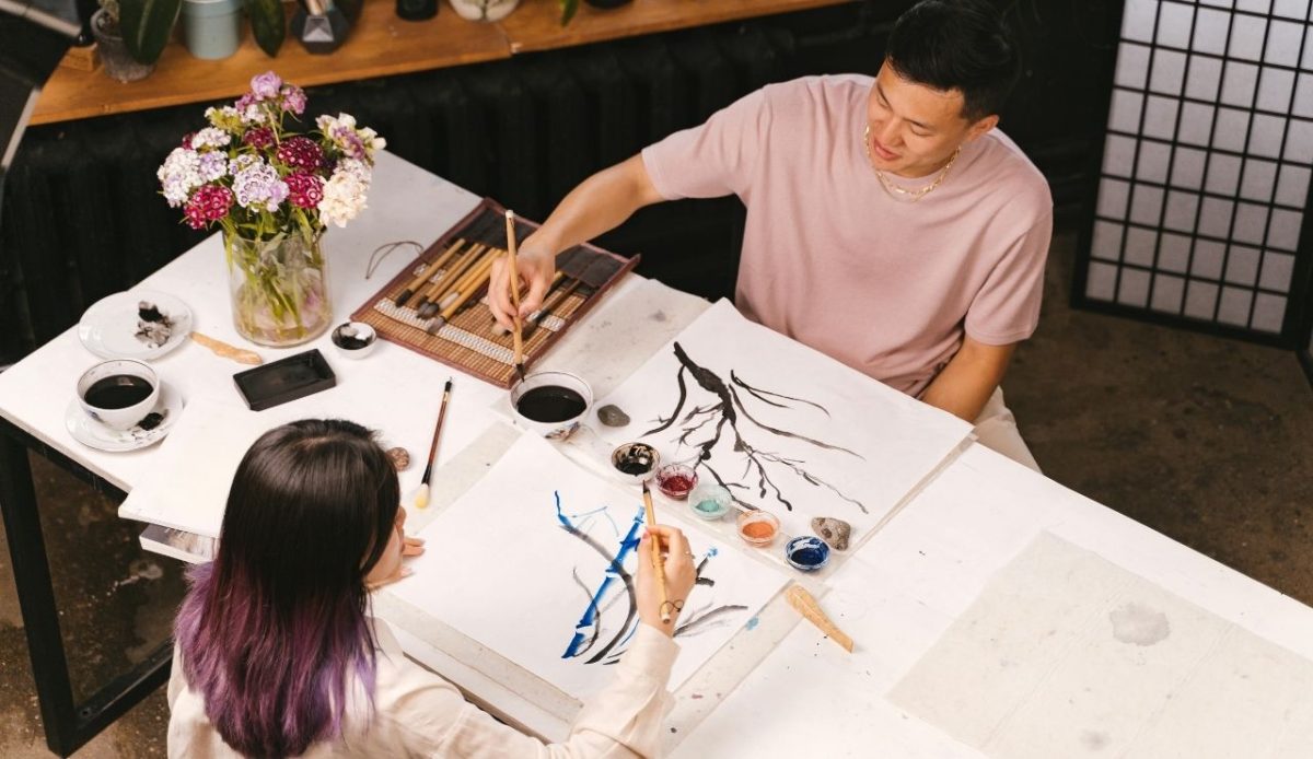 Woman in White Crew Neck T-shirt Painting on White Table                          