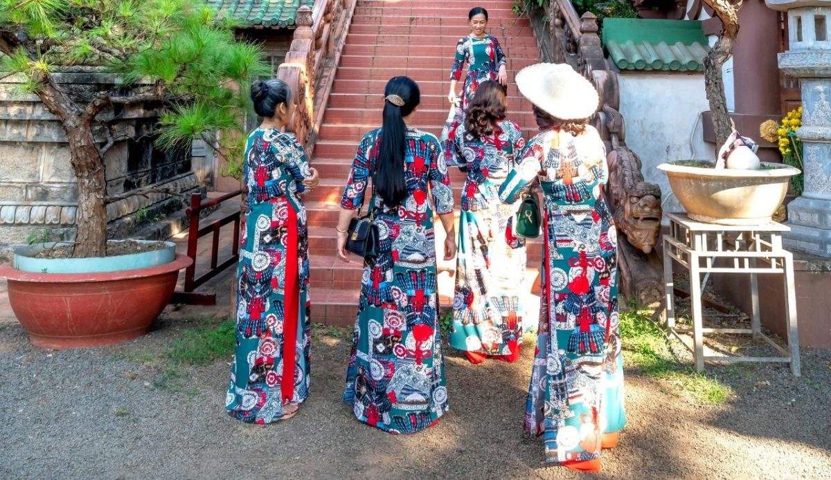 Women in Traditional Clothing by a Stairway at Minh Thanh Pagoda                      