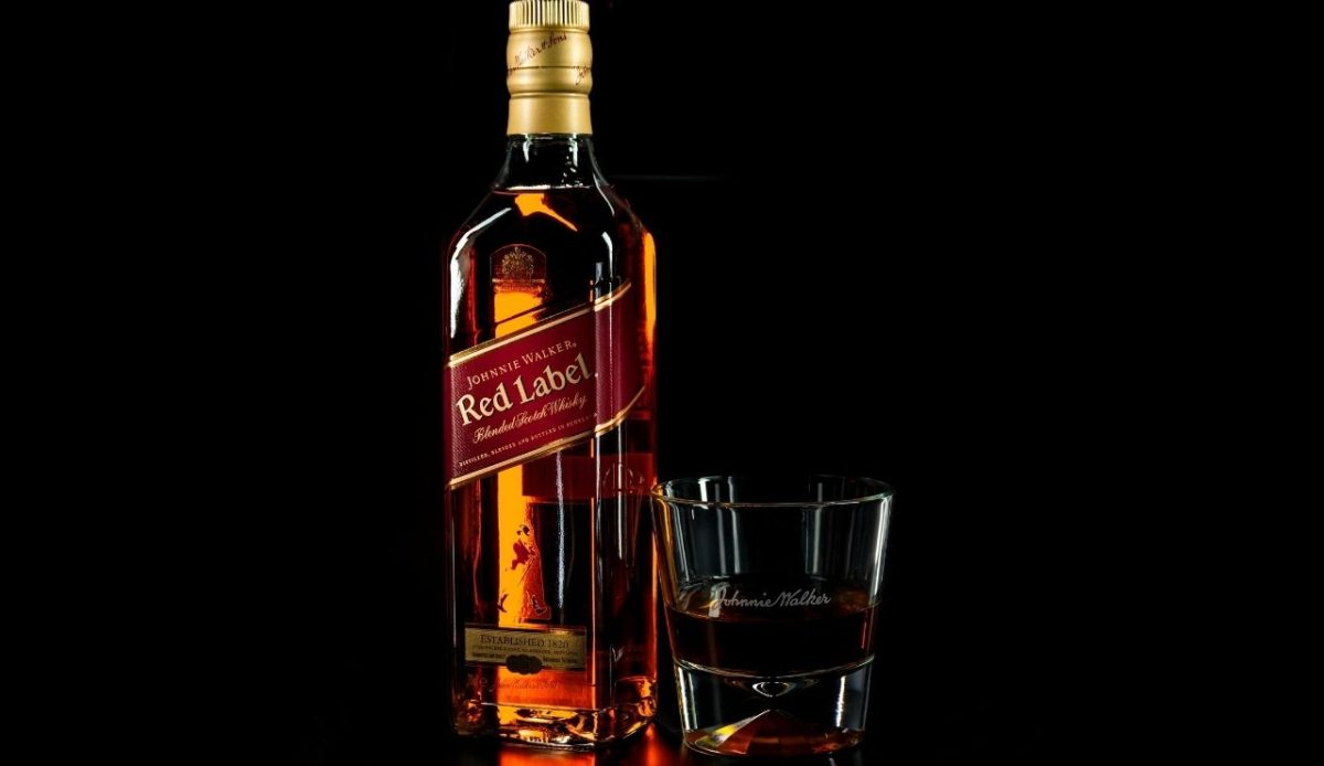 a bottle of alcohol with glass               