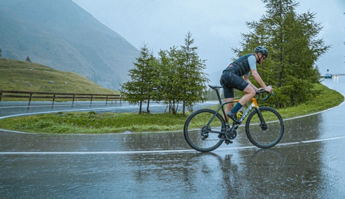 a man is riding a cycle during rain                        