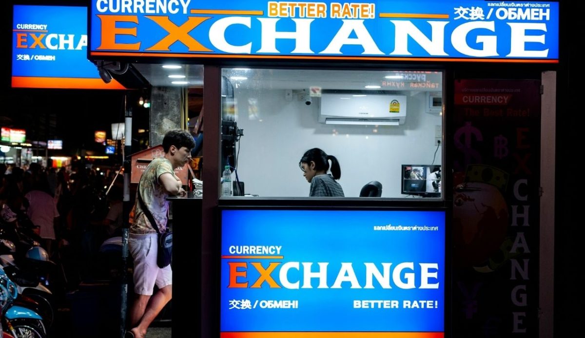 a man is standing at currency exchange cabin                       