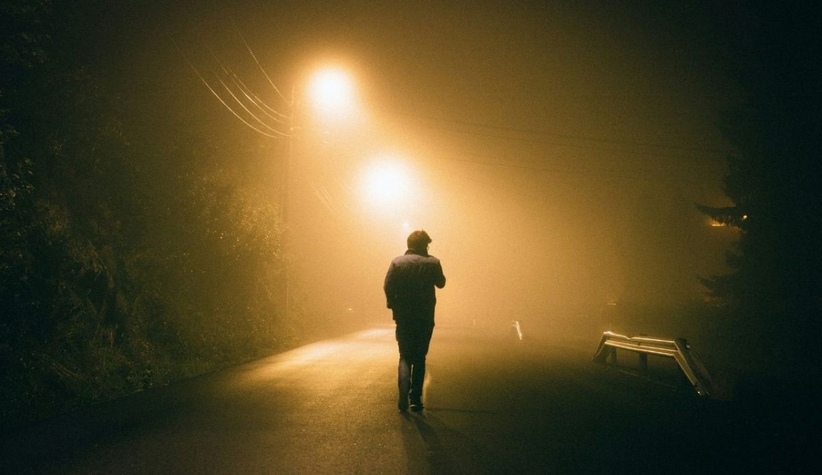 a person is walking at night                 