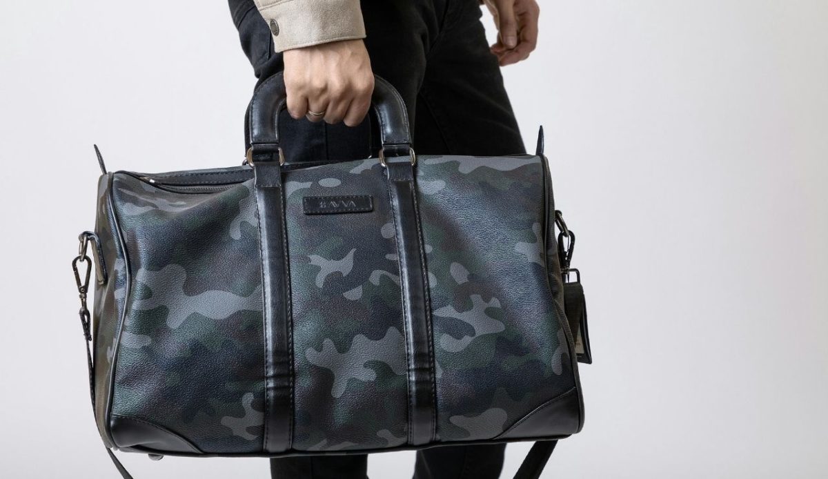 a traveler with small carry on bag in his hand