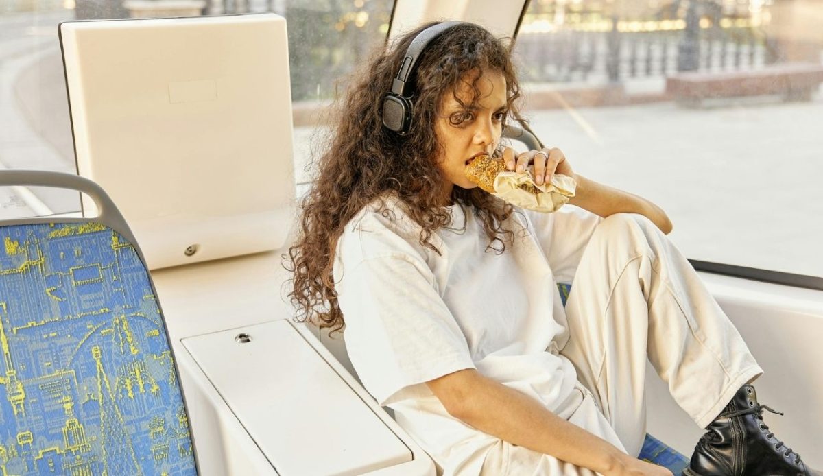a woman is eating in train
