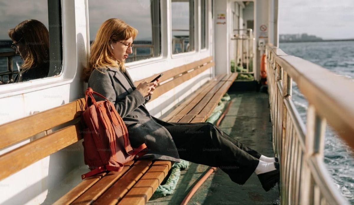 a woman is using mobile phone at cruise ship