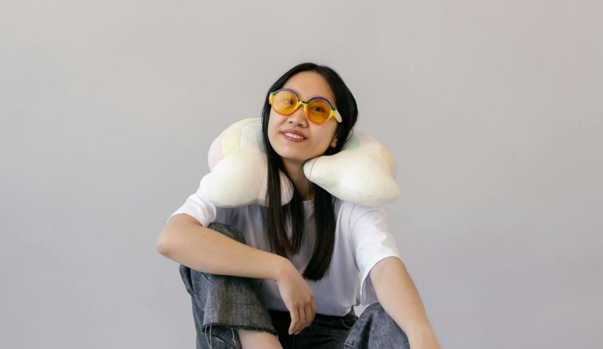 a women with neck pillow around her neck                         